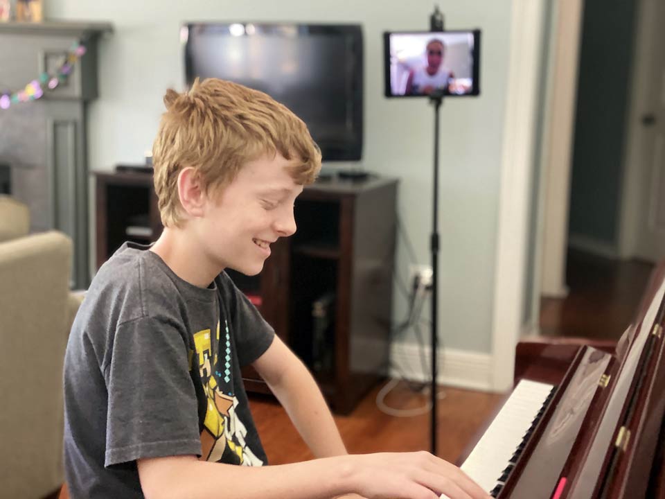 Boy taking an online piano lesson in Kenner, LA